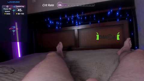 Media: A video of a man's legs, feet, and a wooden headboard with a glowing green \"Craft Rate\" display. A string of blue fairy lights adorns the background.