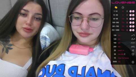A video features two young women with long dark hair, one in a white shirt with a blue graphic, and the other in a gray top, both smiling. A livestream overlay shows chat and stats.