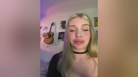 Media: A video of a young woman with long blonde hair and fair skin, wearing a black choker, standing in a bedroom with a guitar on the wall, colorful posters, and a soft purple light.