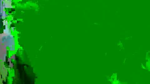 A digital image with a green screen background, featuring a blurry, pixelated, and partially obscured figure on the left side, suggesting an actor or model. The figure's features are indistinct, adding an air of mystery and anticipation.
