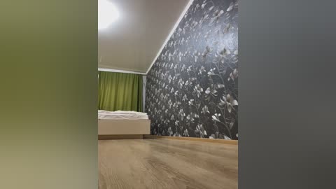 Media: Video of a modern bedroom with a green curtain, white bed, and a wall with a floral pattern. The floor is wooden.