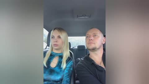 Media: A video of a blonde woman with a blue tie-dye top and a bald man in a black shirt sitting side by side in a car.