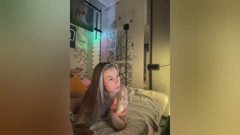 A candid video of a young woman with long, blonde hair lying on a bed, holding a phone, in a dimly lit, cozy bedroom with a rustic aesthetic.