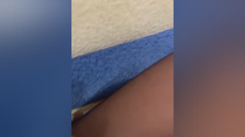 Media: Close-up video of a cross-section of a fabric swatch showing three layers: a beige top layer, a blue middle layer, and a brown bottom layer.