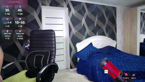 Media: Video of a modern bedroom with a white headboard, blue quilt, and black chair, set against grey, diamond-patterned wallpaper.