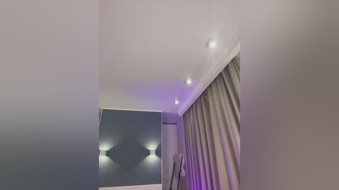 Media: Video of a modern, dimly lit room with a large mirror reflecting a minimalist decor, including a single light fixture.