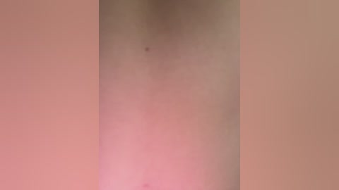 Media: Video of a nude human torso with a slight pinkish hue, no discernible features, blurred background, focusing on skin texture.