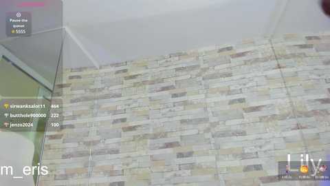 Video of a modern interior featuring a beige and gray stone-textured wall, with a VR headset display showing social media comments and a user's avatar in the corner.
