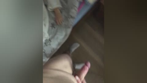 Video of a young child in a white pajama top, standing near a mirror. The child's face is not visible. A hand holding a pink dildo is shown in the foreground, partially obscuring the mirror's reflection.