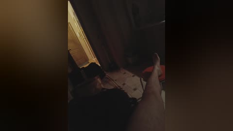 A dimly-lit video captures a person lying on the floor, possibly unconscious, with a faint glow from a doorframe in the background.