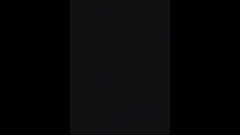Video of a black vertical rectangle against a black background, creating a stark, minimalist composition. The texture is smooth, with no discernible patterns or objects.
