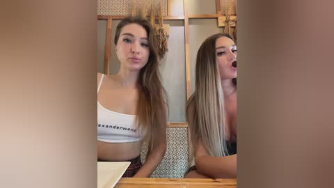 Media: Video of a young Caucasian woman with long, straight blonde hair, wearing a white crop top and black shorts, blowing a kiss into a mirror.