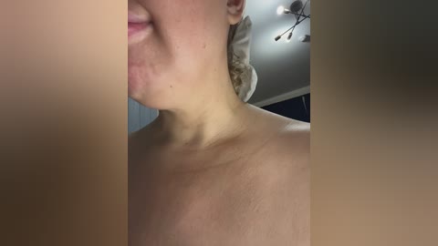 Video of a close-up side profile of a fair-skinned person with short, light brown hair. The image is slightly blurry, revealing a bare shoulder and a hint of a smile.