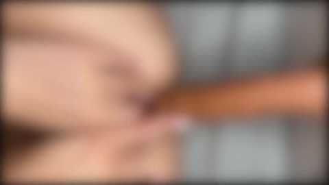 The image is a blurred video, making it difficult to discern specific details. The focus appears to be on a close-up of a person's face, possibly engaged in an intimate act.