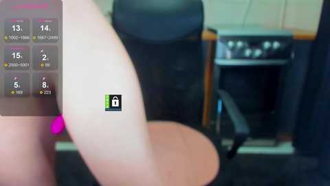 Video of a virtual reality (VR) headset showing a person's leg and a black chair in a room with a TV and gaming console.