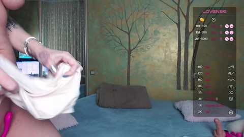 A video captures a woman in a pink dress removing a beige garment, while a virtual reality headset displays a forest scene.