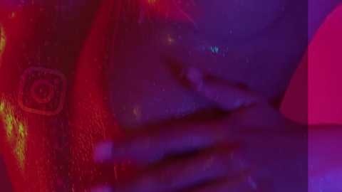 Media: A close-up video of a person with dark skin, partially obscured by a red and purple filter. The individual\u2019s hand covers their mouth, adding a sense of mystery and intrigue.