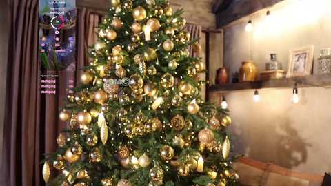 Media: A video of a decorated Christmas tree with golden baubles and lights, in a cozy, warmly lit living room with wooden beams, a fireplace, and a rustic decor.