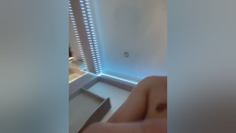 Media: A video shows a person's leg with a tattoo, lying on a white bed with LED strip lights, creating a modern, minimalist bedroom ambiance.