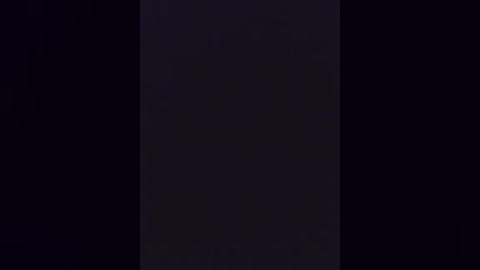 A video showing a vertical black rectangle centered in a pitch-black background, creating a stark contrast. The image is devoid of any additional elements or details.