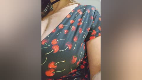 Media: A video of a person with light skin wearing a black choker, a black mask, and a dark green top adorned with cherry print. The background is blurred.