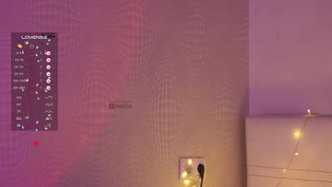 A video of a beige wall with a digital clock, a power outlet, and a string of fairy lights, featuring a soft purple and pink ambient lighting.