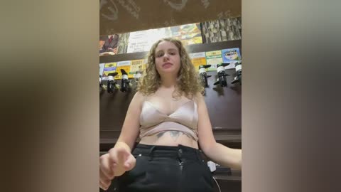Media: A video of a young woman with curly hair, wearing a white crop top and black pants, standing in a toy store, surrounded by colorful toy displays.