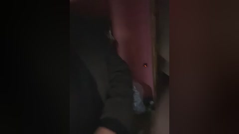 Media: A dimly lit video showing a person with a pink, slightly open mouth, likely in a deep sleep, with a small light illuminating their face. The background is dark and indistinct.