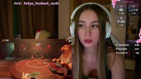 Media: A video of a young woman with long brown hair wearing headphones, playing a video game with a dog character.