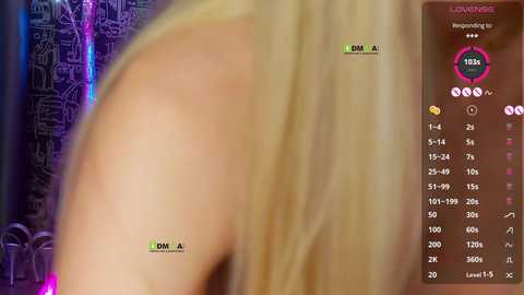 Video of a blonde woman's bare back with a green \"DM\" logo and a \"1999\" tattoo on her shoulder. Background features neon lights and a black and white digital art design.