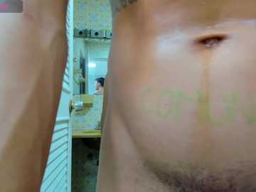 Media: Video of a close-up of a person's right eye and nose, with blurred background of a bathroom with a yellow-tiled shower and sink.