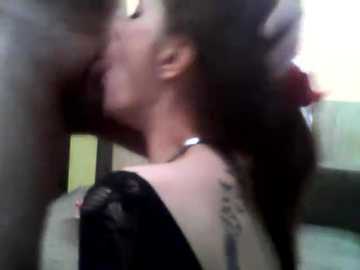 A blurry video depicts a close-up of a person with shoulder-length dark hair, wearing a black lace top and a silver necklace, leaning against a window.