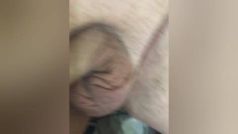 A blurry video of a person with fair skin and light brown hair, possibly a young woman, lying down with eyes closed. The image is out of focus, making it difficult to discern details.