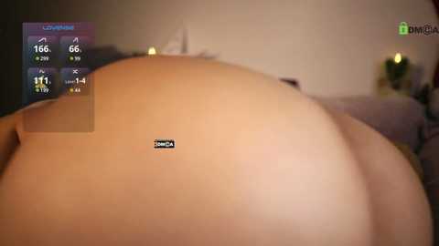 Media: Video of a pregnant woman lying on her back, displaying her large belly with a small black heart sticker on her skin. Background shows blurred furniture and a digital health app screen with heart rate and temperature readings.