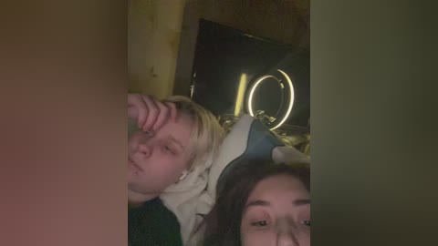 Media: A dimly-lit video shows two women, one with blonde hair and a bandage on her head, and another with long dark hair, both looking tired and distressed.