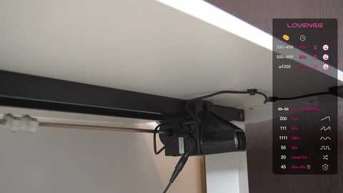 Media: A video of a black camera bag hanging from a ceiling track system in a modern room. The image includes a digital overlay showing camera settings and a \"Lowepro\" logo.
