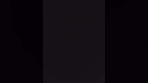 A video of a dark, narrow vertical slit against a black background, suggesting a minimalist, abstract aesthetic with a focus on contrast and simplicity.