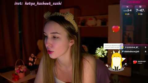 Media: Video of a blonde woman with a cat headband in a dimly lit room, overlaid with social media icons and text.