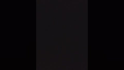 A video of a black background with a vertical white stripe in the center, creating a minimalist, abstract composition. The image is devoid of any objects, textures, or colors other than black and white.