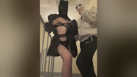 A video of a woman in black lingerie and fishnet stockings being carried by a man in a white hoodie and panda mask, in a dimly lit hallway.