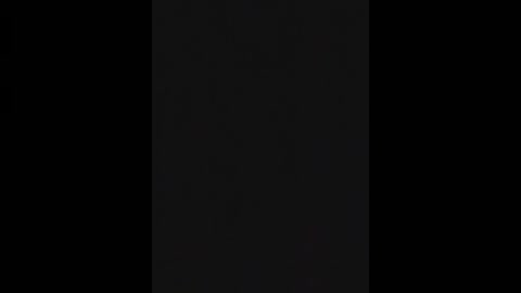 Media: This is a minimalist, digital image featuring a tall, vertical black rectangle set against a solid black background, creating a stark, monochromatic composition. The rectangle's edges are clean and sharp, emphasizing its simplicity and modern aesthetic.