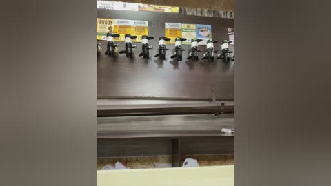 Media: A video of a dark wooden counter with rows of white LEGO figurines dressed as police officers, positioned above a yellow counter, in a brightly lit, possibly fast-food restaurant setting.