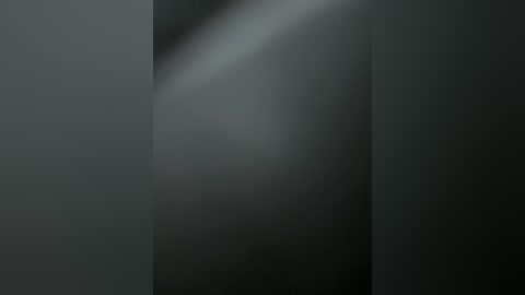 A digital artwork with a soft, ethereal quality, featuring a blurred, gradient of dark grey and black hues, creating a sense of depth and mystery.