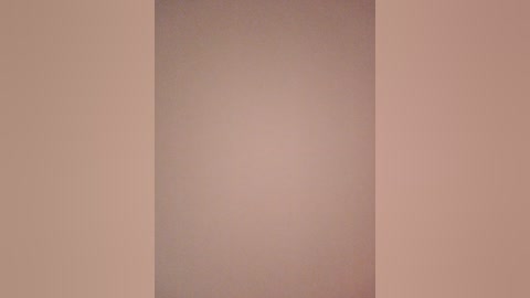 A video of a beige wall with a subtle gradient effect, transitioning from a light beige on the left to a darker beige on the right. The texture appears smooth and uniform, lacking any visible patterns or objects.