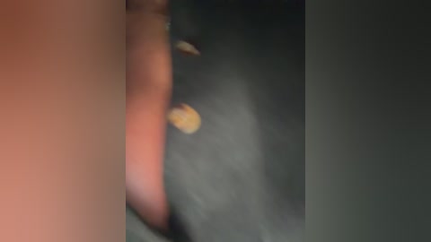 A blurry, close-up video of a human eye, showing a dark iris, a light-colored pupil, and a red blood vessel on the lower eyelid. The background is indistinct.