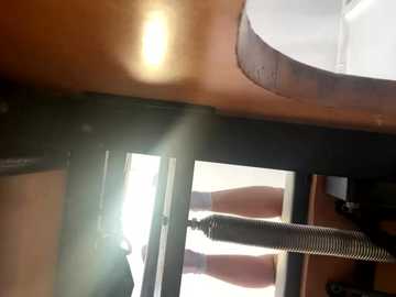 Video of a modern kitchen countertop with a glossy, smooth surface and a built-in retractable faucet. The image is slightly overexposed, causing a lens flare in the upper left corner.