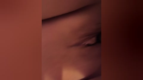 Video of a close-up, blurred eye in a dark, reddish-brown background, creating a dramatic, intimate atmosphere.