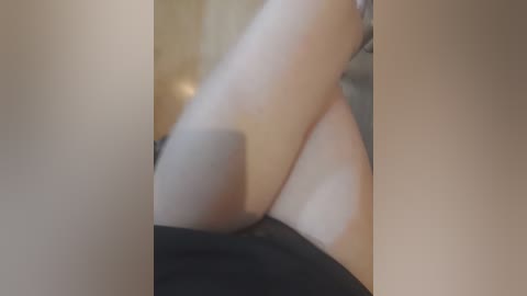 Video of a close-up view of a woman's bare legs and thighs, focusing on the smooth skin texture and pale skin tone. The background is blurred, suggesting an indoor setting.