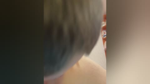 A close-up video showing a person's hand with light skin and manicured nails, gently touching a grey-haired person's head, creating a tender moment of affection.