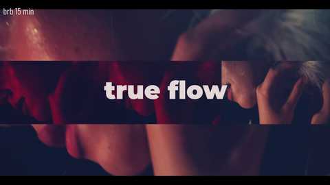 A close-up video featuring a blurred, intimate moment between two people. The background is dark, with the words \"true flow\" in white text overlaying a horizontal red line.